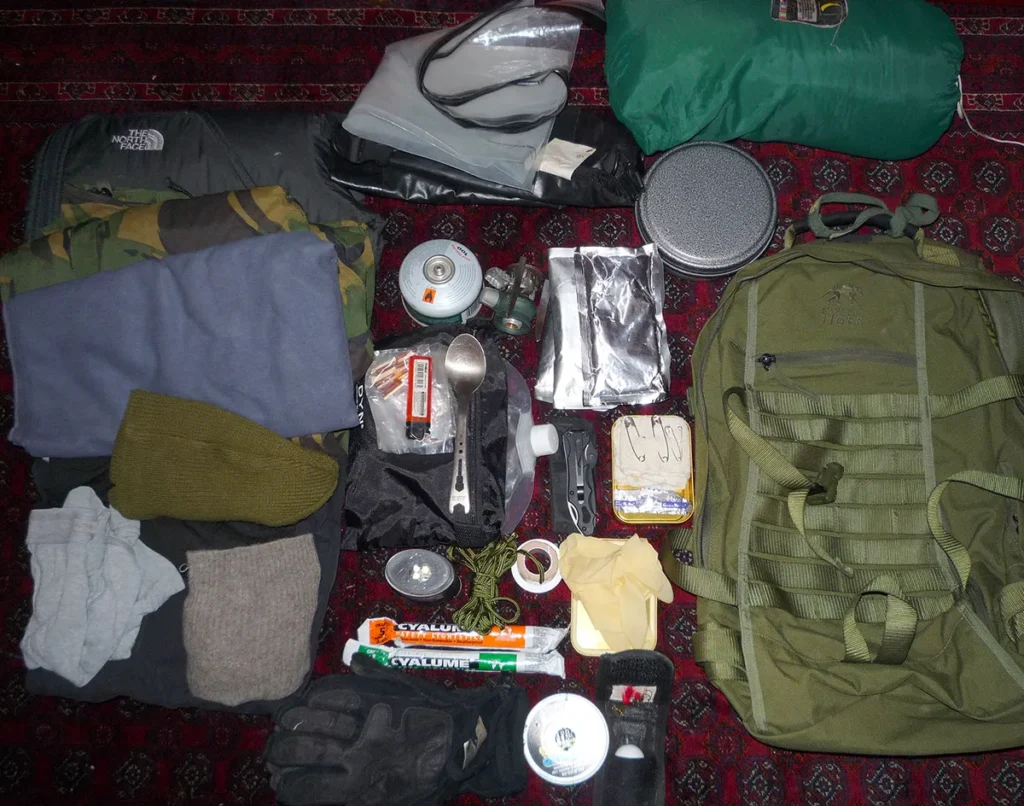 Iemand die een bug-out bag inpakt met waterdichte zakken en georganiseerde vakken