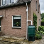 regenwater opvangen met een regenton die is aangesloten via een regenpijp