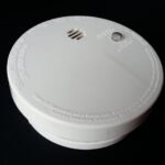 Witte rookmelder op batterij van dichtbij